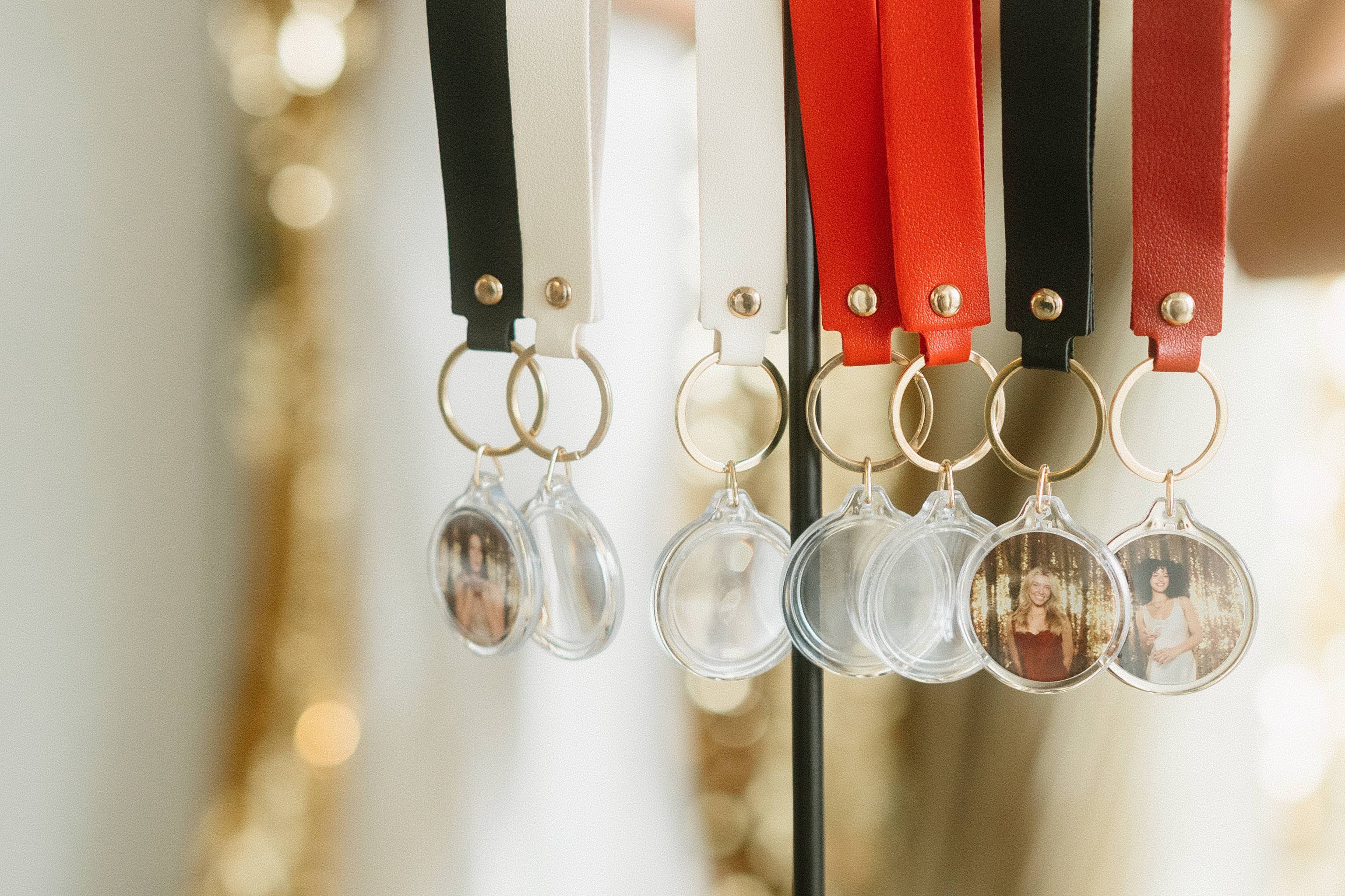 A row of photo keychains hanging from ribbons