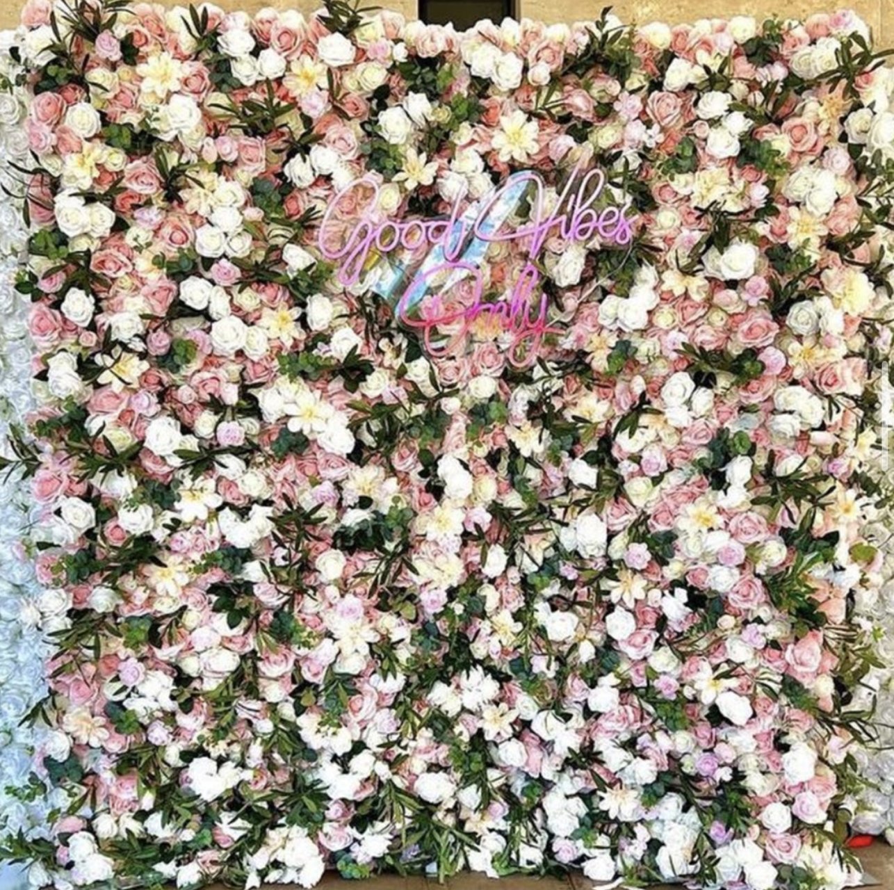The Lily flower wall: pink and white blooms, with a neon sign