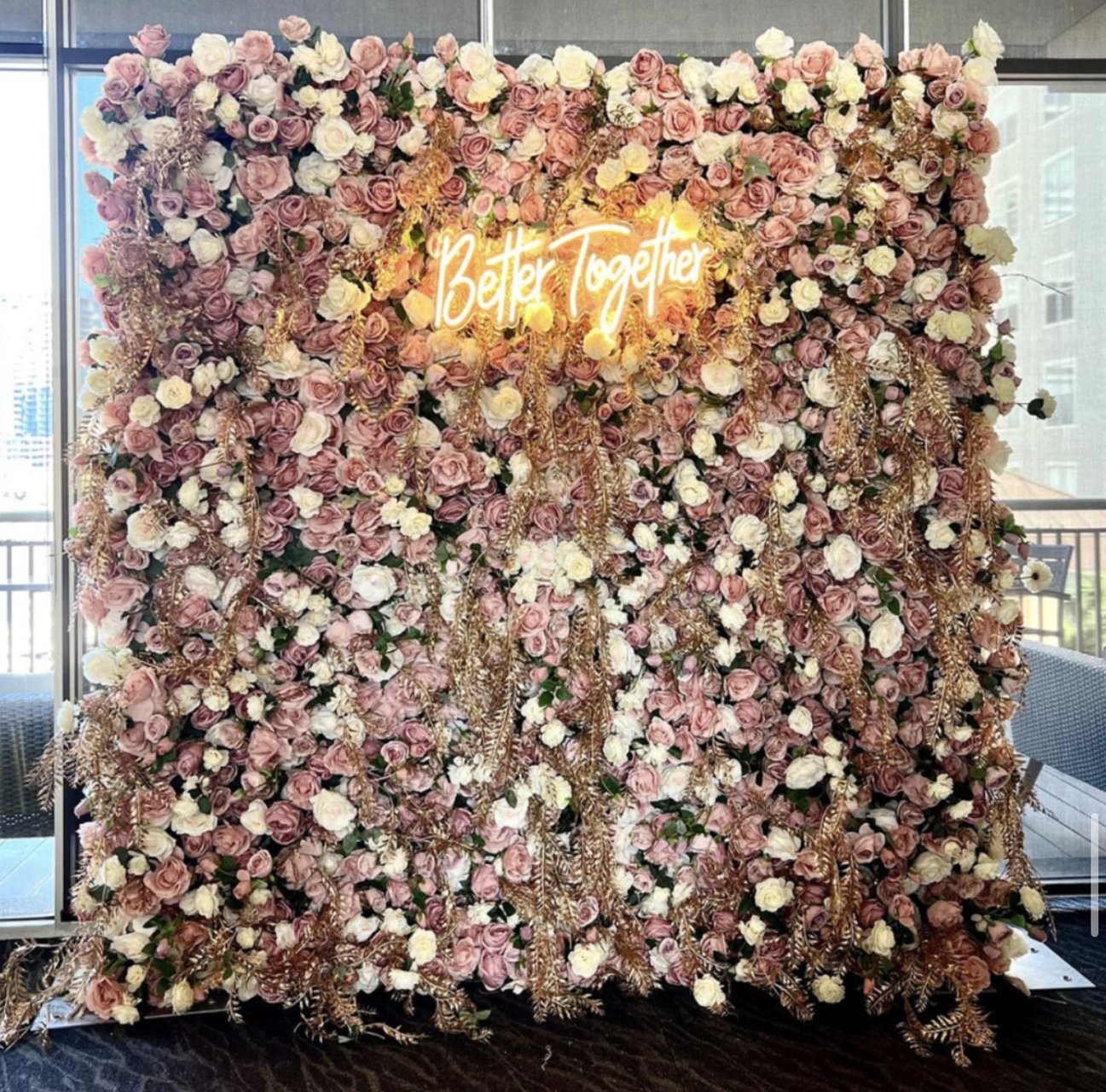 The Mia flower wall: blush, cream and mauve blooms, with a neon sign